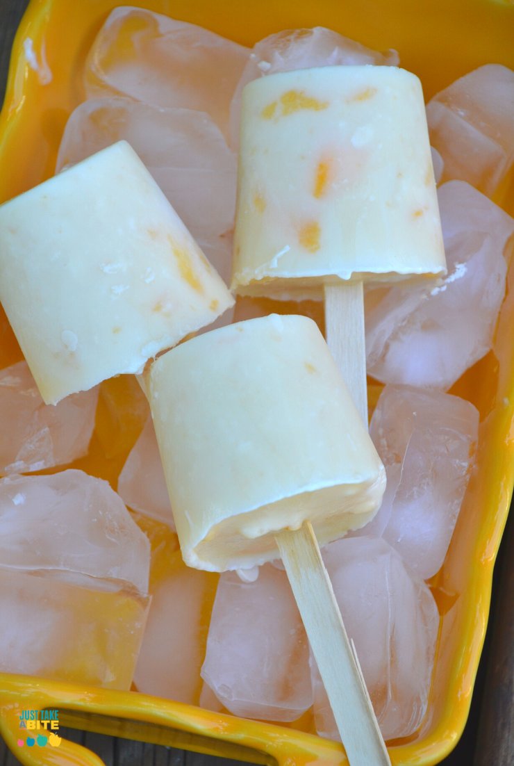 Looking for a delicious way to cool down in August? These grain-free peach cobbler creamsicles are made with just a few simple ingredients and kids love them! Put your extra peaches to good use with this fun summer treat. #peaches #frozentreat #summerfood #kidfood